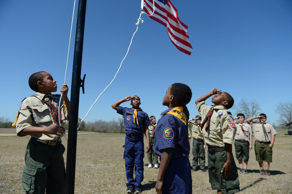 Scout raising flag